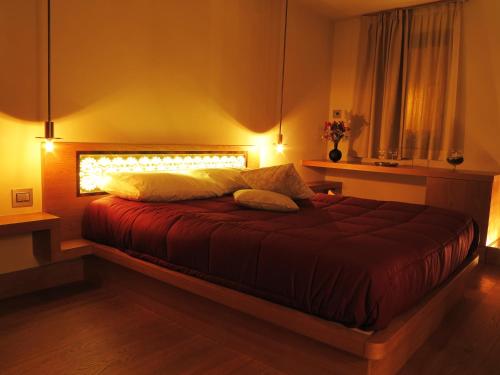 a bedroom with a large bed with lights on it at Mario's Garni in Pescocostanzo