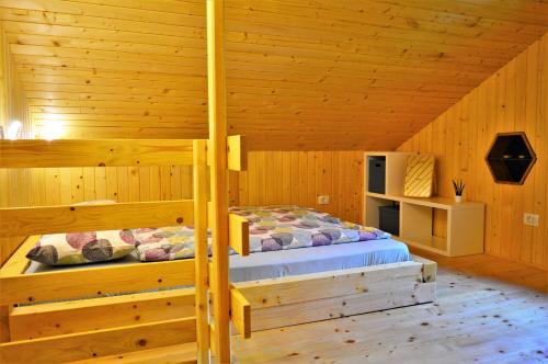 a bedroom with two bunk beds in a log cabin at Sleeping with the bees Kozjak in Kobarid