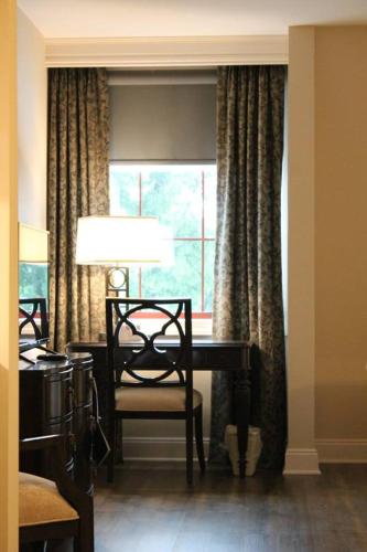 a dining room with a table and a window at Norwalk Inn & Conference Center in Norwalk