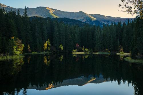 a view of a lake with mountains in the background at Hotel Jasná in Demanovska Dolina