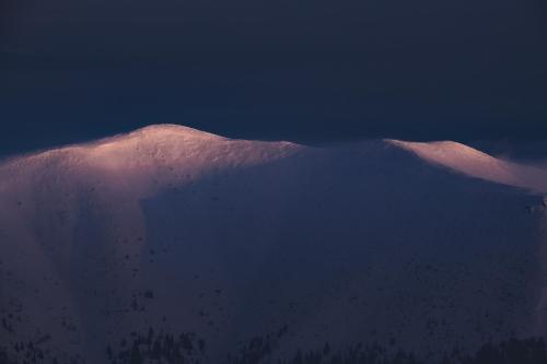 a mountain covered in snow in the distance at Hotel Jasná in Demanovska Dolina