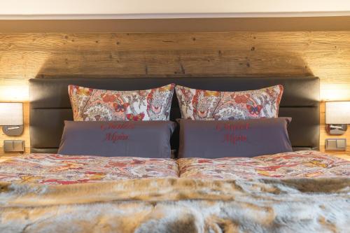 a bed with two pillows on top of it at Chalet Alpin in Oberstdorf