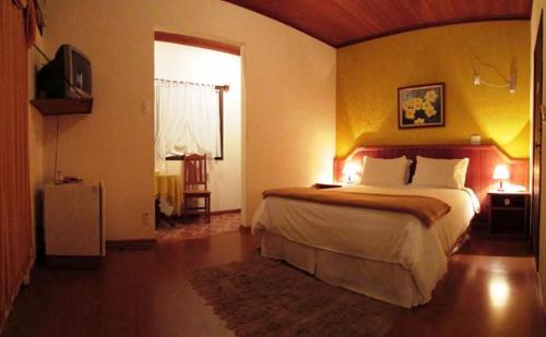 Cheiro de Mata Pousada e Restaurante Ltda tesisinde bir odada yatak veya yataklar