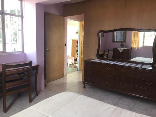 a bedroom with a dresser and a mirror on the wall at Casona del Ropero in Guanajuato