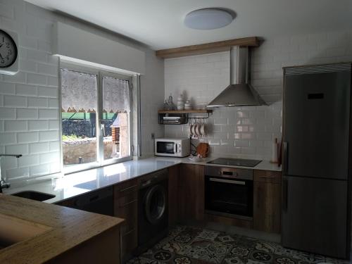 a kitchen with a refrigerator and a stove top oven at La Konerie in Cangas de Onís