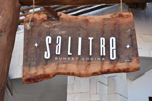 a sign that reads summer sunset cochin hanging from a ceiling at Hotel Rio Lagartos in Río Lagartos