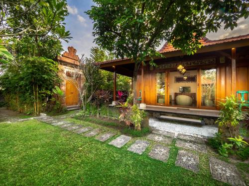 a house with a garden in front of it at Tiis Garden Puri Villas in Gianyar