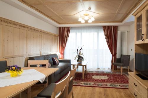 a living room with a couch and a table at Residence Isabell in Selva di Val Gardena