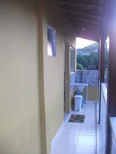a hallway of a house with a sink and a toilet at Casa do Gilberto in Ilhabela