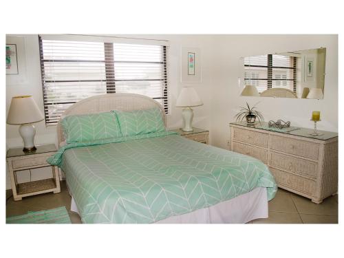 a bedroom with a bed and two night stands at 8 Villa Martinique in Freeport
