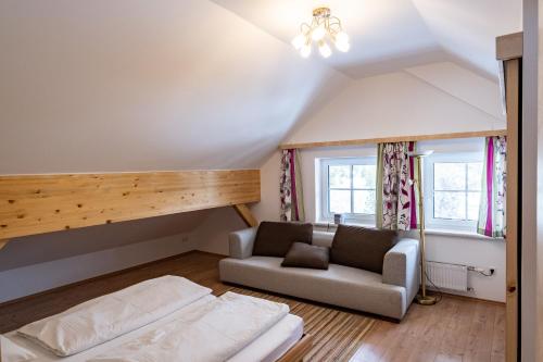 a living room with a couch and a bed at Peters Alm in Turracher Hohe