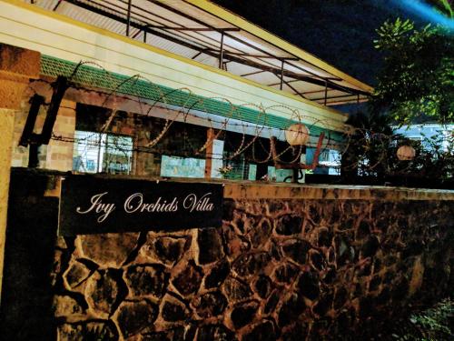 a sign for a try authentic villa at night at Ivy Orchids Villa - Lonavala in Lonavala