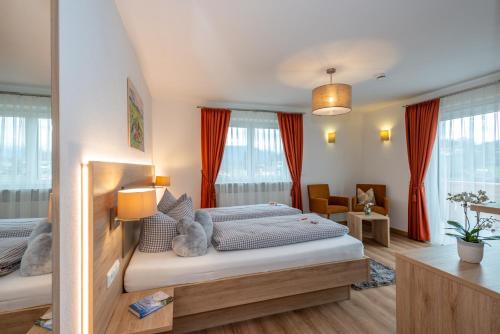 a bedroom with two beds in a room at Boutique Hotel Angerer in Murnau am Staffelsee