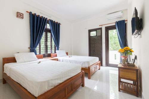 Postel nebo postele na pokoji v ubytování New Destination Hoi An