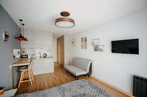 a living room with a table and a kitchen at Tedy's Apartments in New Gudauri in Gudauri