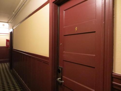 a red door in a room with a hallway at Hotel North Beach in San Francisco