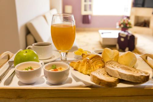 a tray of food with bread and a glass of beer at TTC Hotel - Ngoc Lan in Da Lat