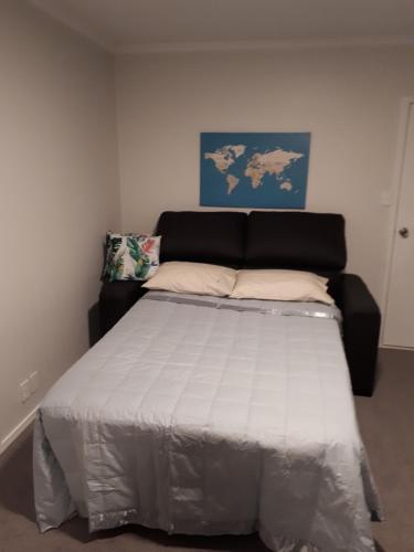 a bed in a room with a large bed at Guest house on Plummers Point in Tauranga