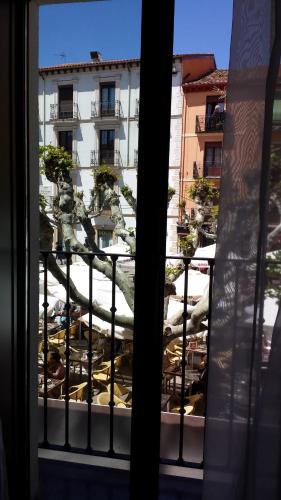 a view from a window of a patio with tables at Hotel Apolonia Soria in Soria