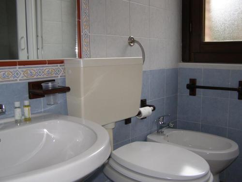 a bathroom with a white toilet and a sink at B&B Le Grazie in Piaggine