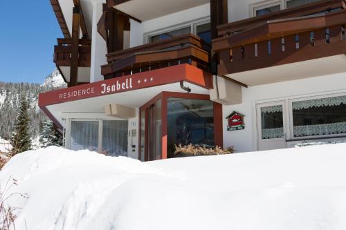 a snow pile in front of a building at Residence Isabell in Selva di Val Gardena