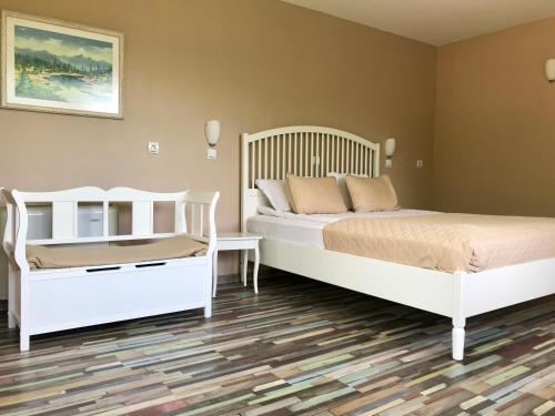 A bed or beds in a room at Yaev Family Hotel