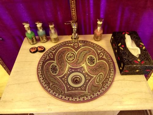 a table with a plate and other items on it at Sahara Majestic Luxury Camp in Merzouga