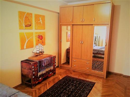 a room with a bedroom with a dresser and a bed at Spacious Apartment in Central Touristic Location in Tashkent