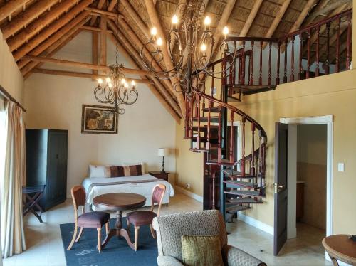 a bedroom with a bed and a spiral staircase at Ridgemor Villa in Somerset West