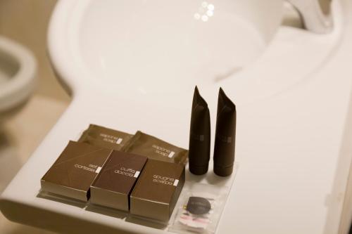 a table with two black boots and some brownies at Style Hotel Grifone in Madonna di Campiglio