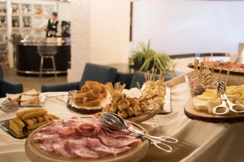 a table with different types of food on it at Style Hotel Grifone in Madonna di Campiglio