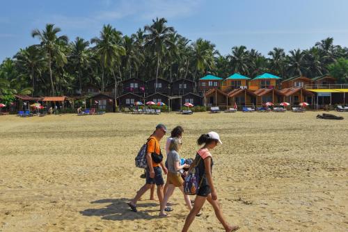 a group of people walking on the beach at Agonda Paradise in Agonda