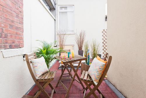 a small patio with a table and two chairs at Five Lamps Suites in Dublin