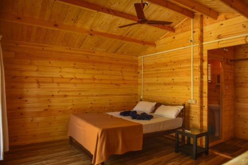 a bedroom with a bed in a wooden cabin at Agonda Paradise in Agonda