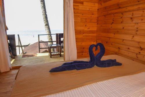 a bedroom with a bed with a heart decoration on it at Agonda Paradise in Agonda