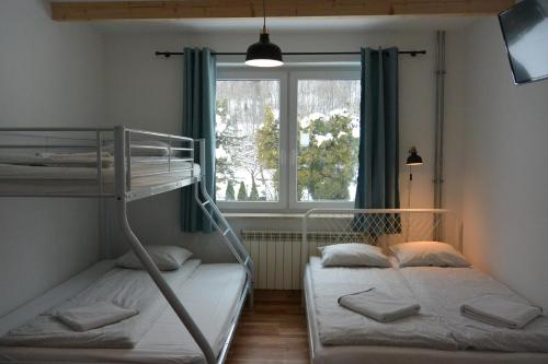 two bunk beds in a room with a window at Willa Skalite in Szczyrk