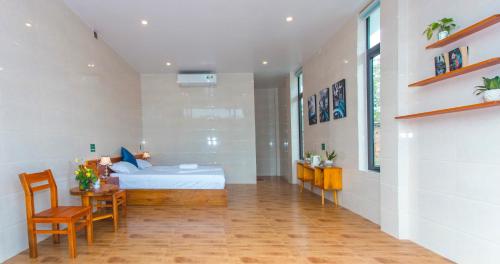 a bedroom with a bed and a table and chairs at Hugo Homestay in Phong Nha