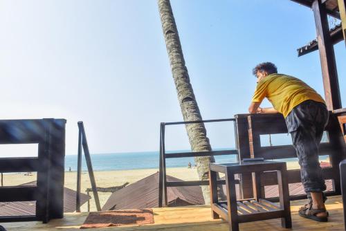a man standing on a bench on the beach at Agonda Paradise in Agonda