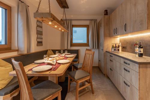a dining room with a table and chairs in a kitchen at Berggasthof Staudachstub'n in Kirchberg in Tirol