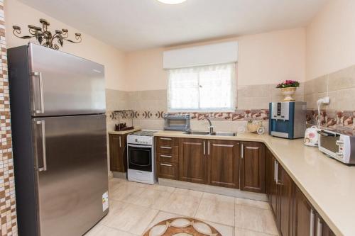 a large kitchen with a stainless steel refrigerator at Lilia's House in Safed