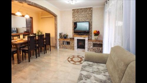 a living room with a couch and a dining room at Lilia's House in Safed