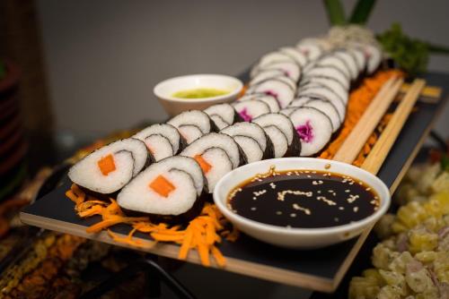 a tray of sushi and sauce on a table at Kevans Casa in Mahiyangana