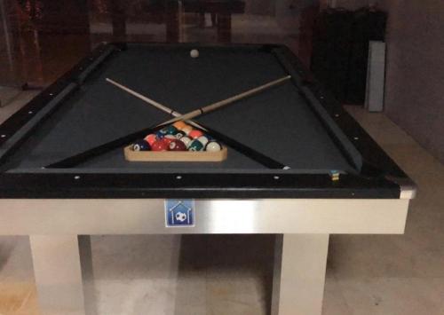 a pool table with two cue sticks in it at Hotel & Resort Golden Marina Yanbu in Yanbu