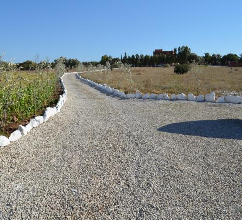 a gravel road with rocks on the side of a field at Casa Naima in Ida Ougourd