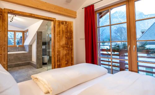 sypialnia z łóżkiem i dużym oknem w obiekcie Gapartments w Garmisch Partenkirchen