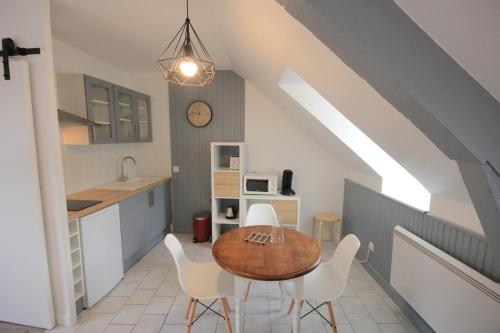 a kitchen and dining room with a table and chairs at Maison Candela in Argelès-Gazost