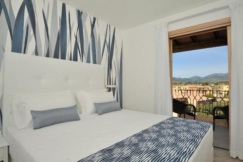 מיטה או מיטות בחדר ב-Amareclub Janna e Sole Resort