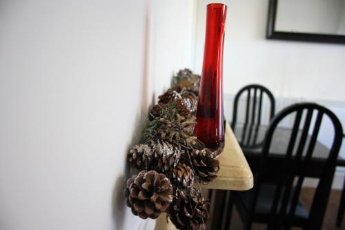 a table with a christmas tree and a red vase at Thanington Hotel in Canterbury