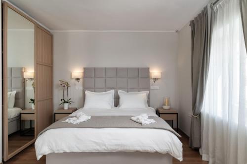 Ένα ή περισσότερα κρεβάτια σε δωμάτιο στο Porto Vecchio Luxury Suites
