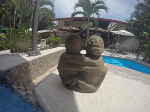 a large teddy bear sitting on top of a swimming pool at Coyaba Tropical Elegant Adult Guesthouse in Manuel Antonio